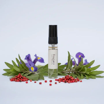 Fragaro 5ml tester perfume bottle with green leaves and red berries on a light blue background