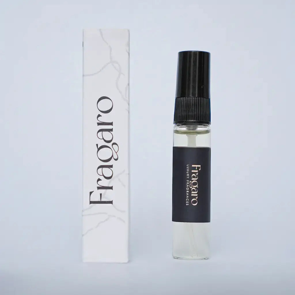Fragaro tester spray vial with black cap next to its white marble-patterned box on a pale background.