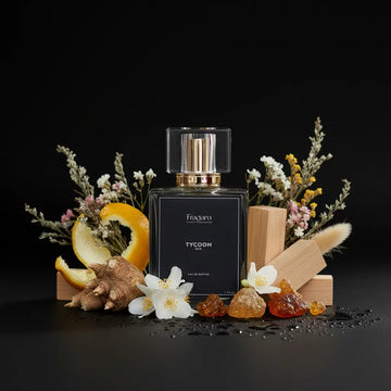 Perfume bottle labeled 'Tycoon' surrounded by flowers and fruits on a dark background
